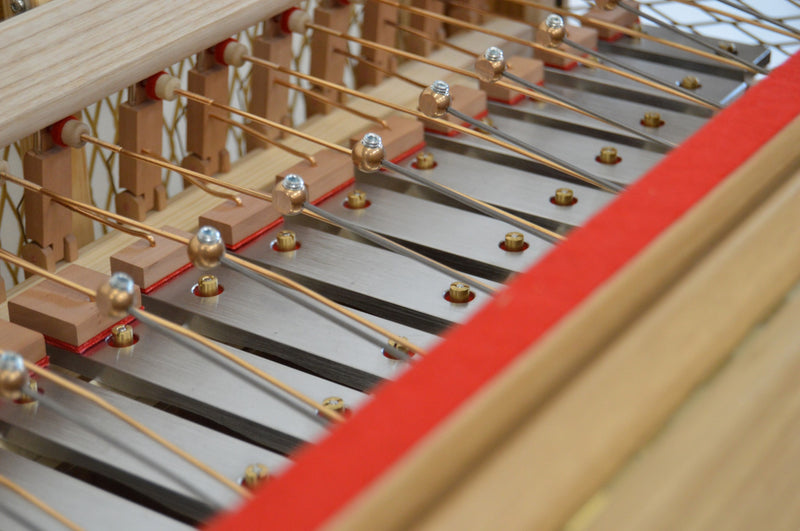 Inside the Schiedmayer keyboard glockenspiel — brass-ball hammers, steel sound plates and red felt dampers